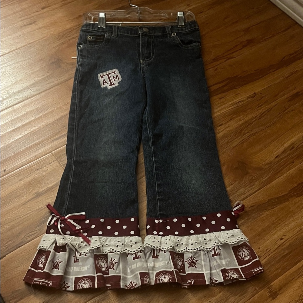 Texas A&M Kids Denim Jeans with Maroon and White Ruffle Accents.